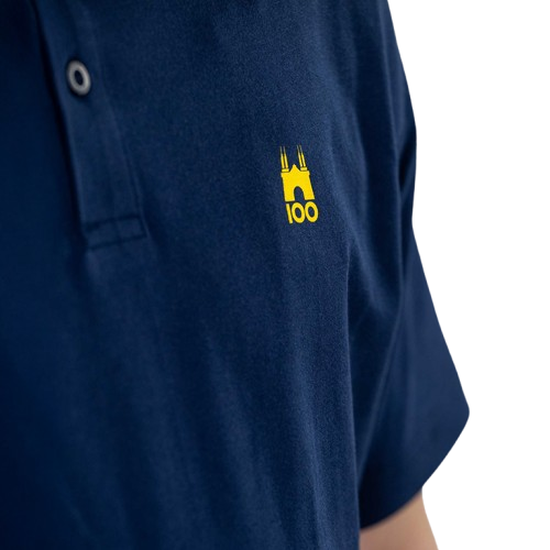 Ragazzo indossa polo blu con logo tardini 100 e puma giallo