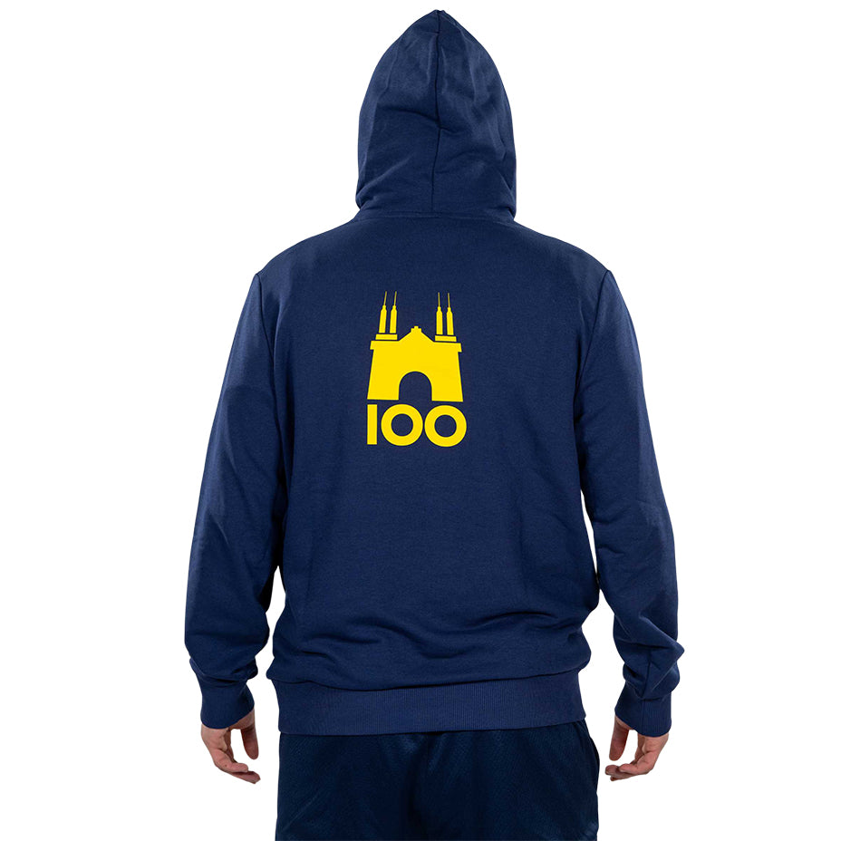 Ragazzo indossa felpa blu con cappuccio logo parma e puma in giallo sul fronte logo tardini 100 sul retro